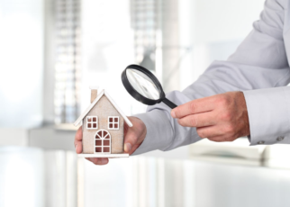 A man inspecting the home to check for possible issues